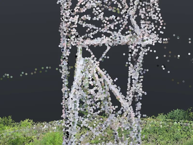 Drone camera view of the top of a lattice tower against the sky